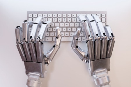 Robotic hands on keyboard